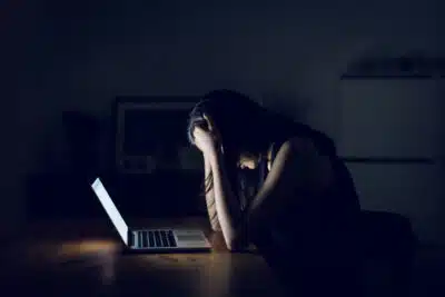 Stressed and frustrated businesswoman working till late at work
