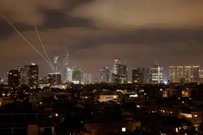 Israeli air defence systems are activated to intercept Iranian missiles over the Israeli city of Tel Aviv amid a fresh barrage of Iranian rockets on June 15, 2025. Israel and Iran traded heavy fire for a third straight day on June 15, with mounting casualties and expanding targets marking a sharp escalation in hostilities between the longtime foes. (Photo by Jalaa MAREY / AFP)