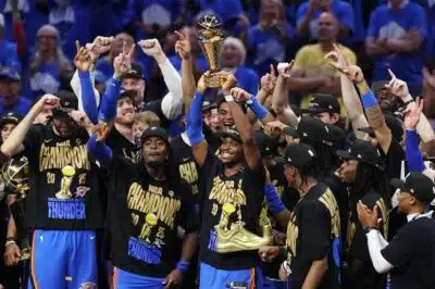 OKLAHOMA CITY, OKLAHOMA - JUNE 22: Shai Gilgeous-Alexander #2 of the Oklahoma City Thunder celebrates with the Bill Russell NBA Finals Most Valuable Player trophy after defeating the Indiana Pacers 103-91 in Game Seven of the 2025 NBA Finals at Paycom Center on June 22, 2025 in Oklahoma City, Oklahoma. NOTE TO USER: User expressly acknowledges and agrees that, by downloading and or using this photograph, User is consenting to the terms and conditions of the Getty Images License Agreement.   Justin Ford/Getty Images/AFP (Photo by Justin Ford / GETTY IMAGES NORTH AMERICA / Getty Images via AFP)