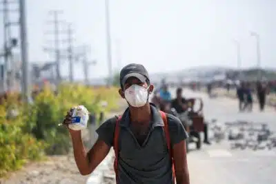Displaced Palestinians at the Nuseirat refugee camp haul food parcels and other items they managed to get from a GHF aid distribution point at the so-called 
