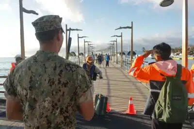 Ecuadorian Navy personnel receive tourists who were aboard boats and were evacuated due to a tsunami warning in Puerto Ayora, Santa Cruz Island, Galapagos, Ecuador, on July 30, 2025. Ecuador ordered on Tuesday the preventive evacuation of beaches, docks, and low-lying areas in the tourist Galapagos Islands, 1,000 km from the mainland, due to a tsunami warning following the 8.8 magnitude earthquake off the east coast of Russia, the Risk Secretariat reported. (Photo by Carlos Villalba / AFP)