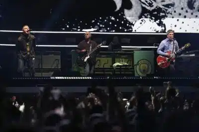 (L-R) Liam Gallagher, lead singer, Paul Arthurs, guitarist and Noel Gallagher, singer and guitarist of British rock band Oasis perform on stage at the Principality Stadium in Cardiff on July 4, 2025, during the opening concert of their highly anticipated reunion tour nearly 16 years after last performing together. Two consecutive nights of concerts at the Principality Stadium in the Welsh capital mark the start of a 41-date run of gigs spanning the world. (Photo by AFP stringer / AFP) / NO USE AFTER JULY 3, 2026 23:00:00 GMT - NO USE AFTER JULY 3, 2026 23:00:00 GMT - RESTRICTED TO EDITORIAL USE - NOT TO BE USED AFTER JULY 3, 2026
