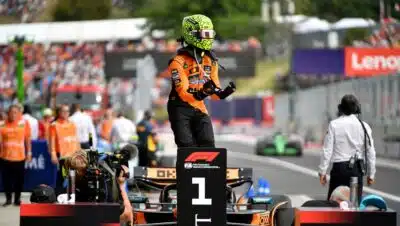 McLaren's British driver Lando Norris (C) celebrates after winning the Formula One Hungarian Grand Prix at the Hungaroring circuit in Mogyorod near Budapest, Hungary, on August 3, 2025. (Photo by Ferenc ISZA / AFP)