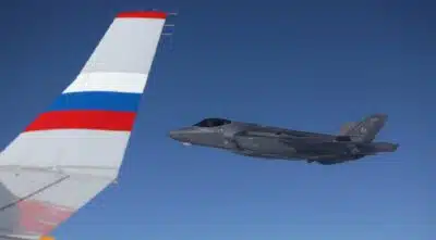 In this pool photograph distributed by the Russian state agency Sputnik, A US F-22 fighter jet escorts a plane with Russian President Vladimir Putin on board following a US-Russia summit in Anchorage, Alaska, on August 15, 2025. (Photo by Gavriil GRIGOROV / POOL / AFP)