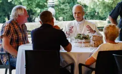 Pope Leo XIV addresses attendees as he holds a festive lunch with the poor of the Diocese of Albano Laziale at Borgo Laudato Si, in the garden of the Pontifical Villas in Castel Gandolfo on August 17, 2025. (Photo by Remo Casilli / POOL / AFP)