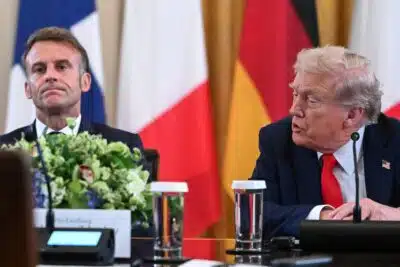 (L/R) French President Emmanuel Macron listens as US President Donald Trump speaks during a meeting with Ukrainian President Volodymyr Zelensky and European leaders in the East Room of the White House in Washington, DC, on August 18, 2025. European leaders join Ukrainian President Volodymyr Zelensky in talks with US President Donald Trump on August 18, as they try to find a way to end Russia's offensive.  The leaders heading to Washington on Monday to appear alongside Zelensky call themselves the 